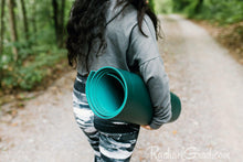 Load image into Gallery viewer, black and women's leggings by Canadian Artist Rachael Grad on women with yoga mat