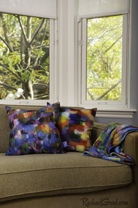 Colorful Art Pillows and Blanket by Artist Rachael Grad on Green Couch