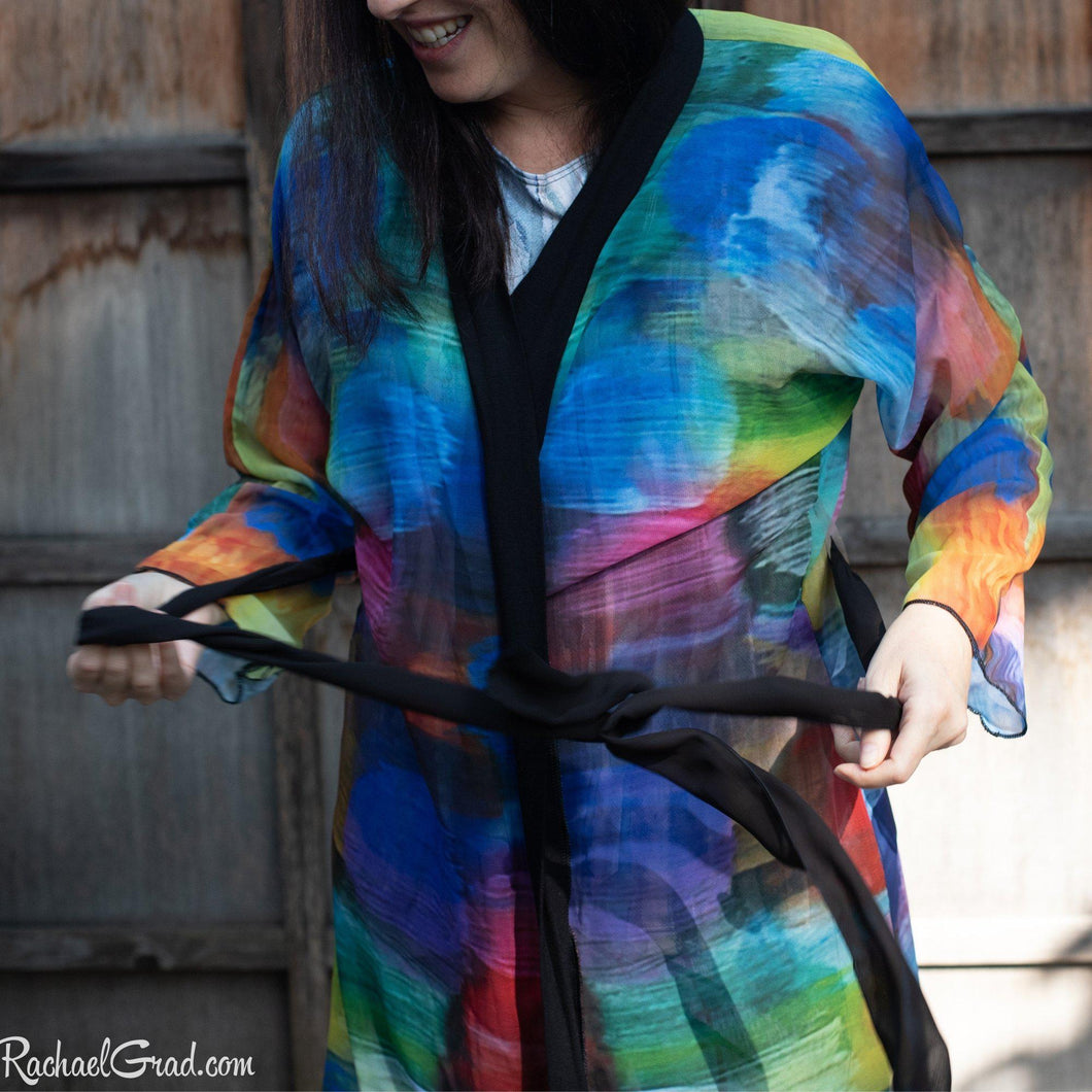 Artist Rachael Grad in colorful bathrobe tying the robe