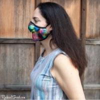 Artist Rachael Grad in rainbow face mask side view
