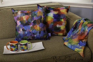 Pillows, blanket and mugs by Artist Rachael Grad on couch