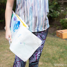 Load image into Gallery viewer, Toronto Artist Rachael Grad in capri art leggings holding palette paper