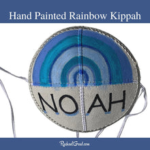 Load image into Gallery viewer, baby kippah with hand painted rainbow art by Canadian artist Rachael Grad closeup
