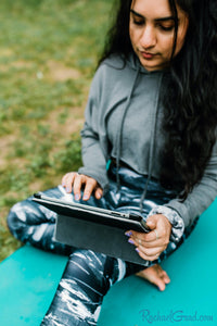 black and women's leggings by Canadian Artist Rachael Grad on women with iPad on yoga mat