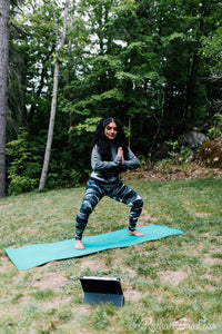 black and white women's yoga leggings by Canadian Artist Rachael Grad in meditative pose
