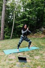 Load image into Gallery viewer, black and white women&#39;s yoga leggings by Canadian Artist Rachael Grad in squatting pose