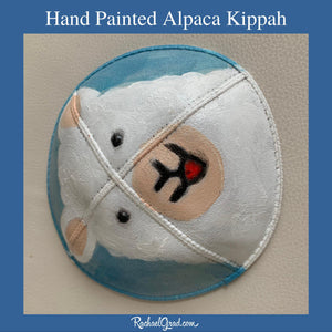 side view hand painted alpaca kippah by artist Rachael Grad Alpaca yarmulkas blue and white