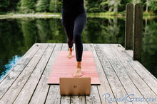 Load image into Gallery viewer, yoga mat by Canadian artist Rachael Grad for pilates on demand on the dock in summer 